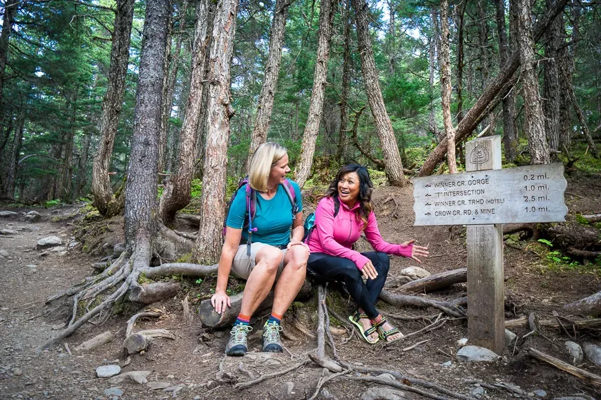 Hikers stop to rest at Winner Creek in anchorage, alaska.